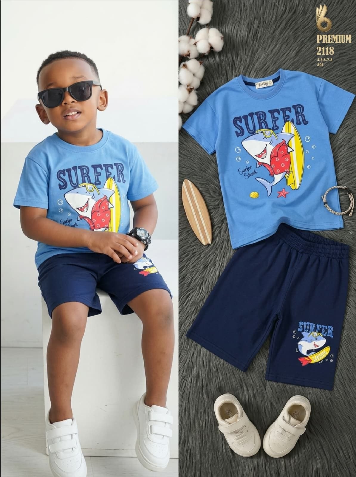 The Nile Luxuries boys blue t-shirt and navy shorts set featuring a fun shark surfer graphic print for summer wear.