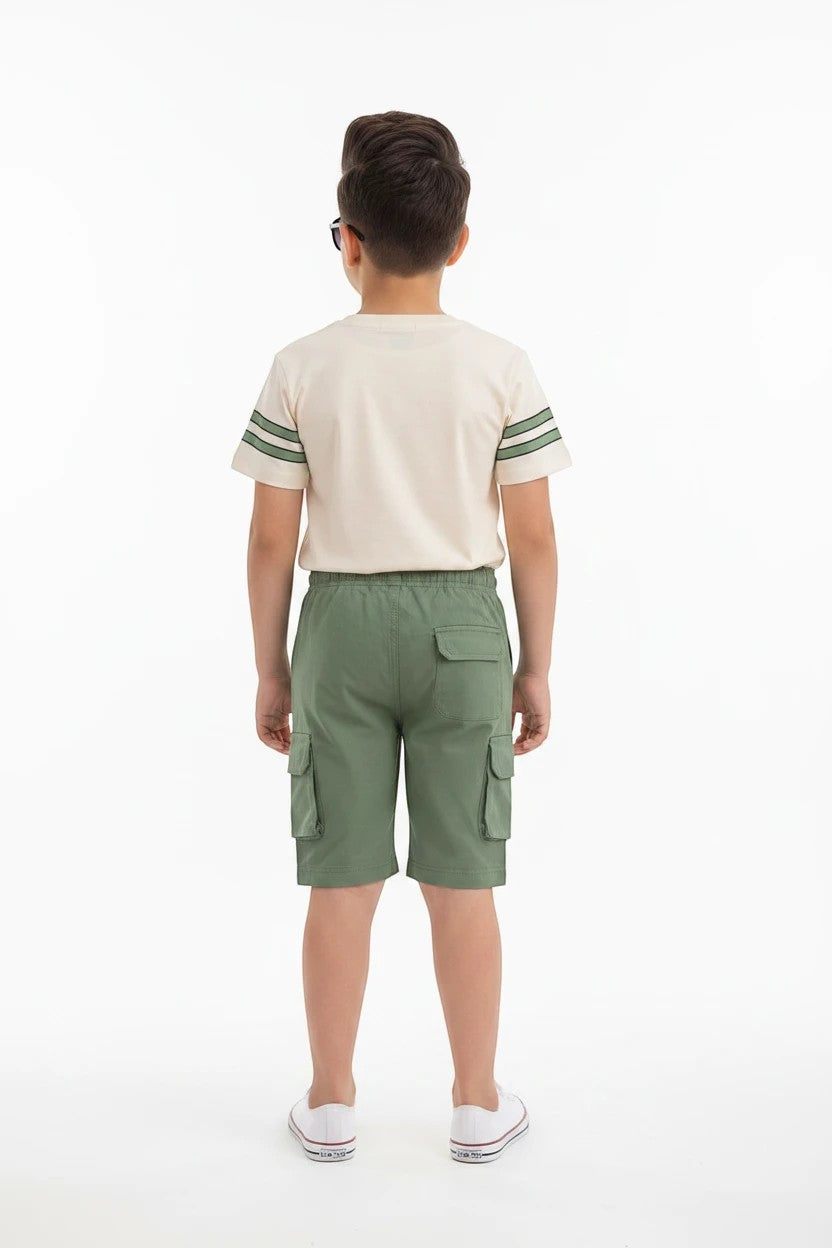 Back view of a boy wearing The Nile Luxuries varsity-style cream t-shirt with green stripes and matching cargo shorts.