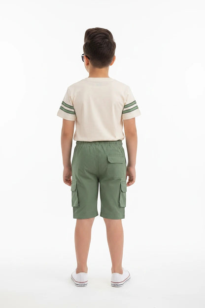 Back view of a boy wearing The Nile Luxuries varsity-style cream t-shirt with green stripes and matching cargo shorts.