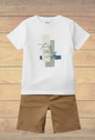 The Nile Luxuries Boys white cotton t-shirt with graphic print and tan shorts. Short sleeves, crew neck.