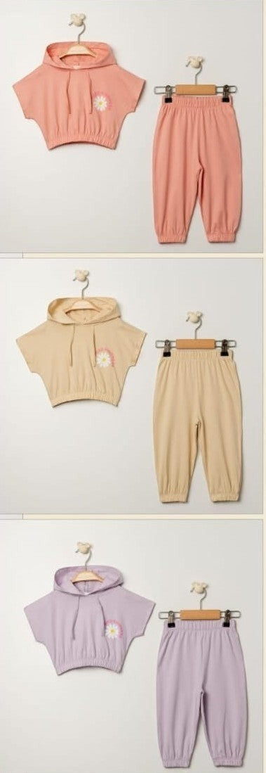 The Nile Luxuries children's casual hoodie and pants set in blush pink, featuring a daisy graphic and 'Spread Kindness' text.