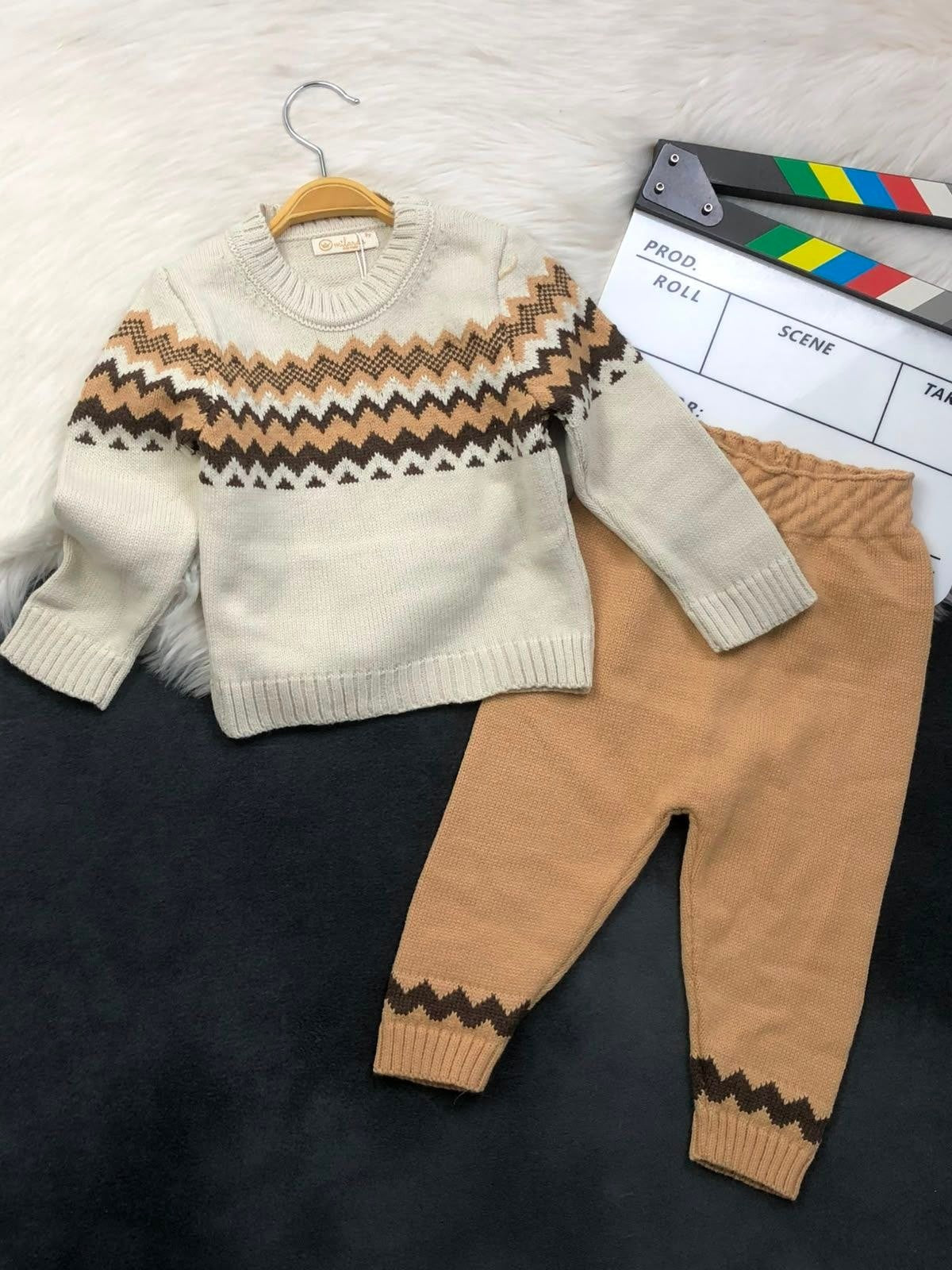 The Nile Luxuries children's knit sweater and pant set in cream and tan with a geometric chevron pattern