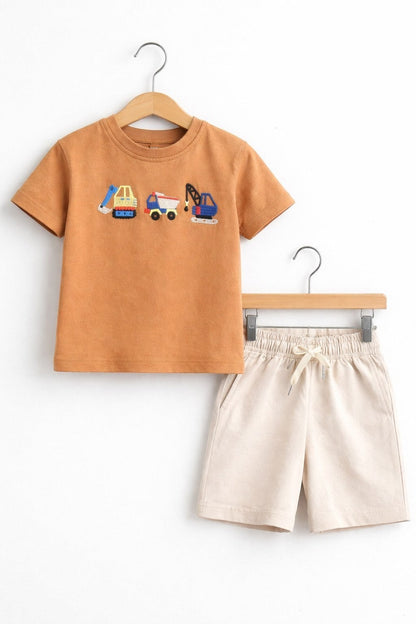 The Nile Luxuries children's set with a tan short-sleeve t-shirt featuring construction vehicle embroidery and beige shorts.