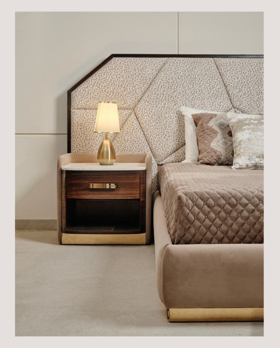 The Nile Luxuries contemporary bedroom set with upholstered headboard, dark wood nightstand, and gold accents.