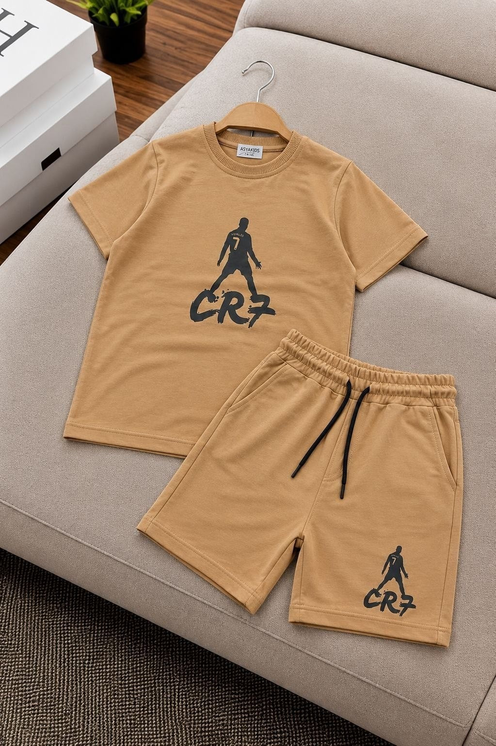 The Nile Luxuries tan athletic t-shirt and shorts set with black CR7 football graphic print and drawstring waist.