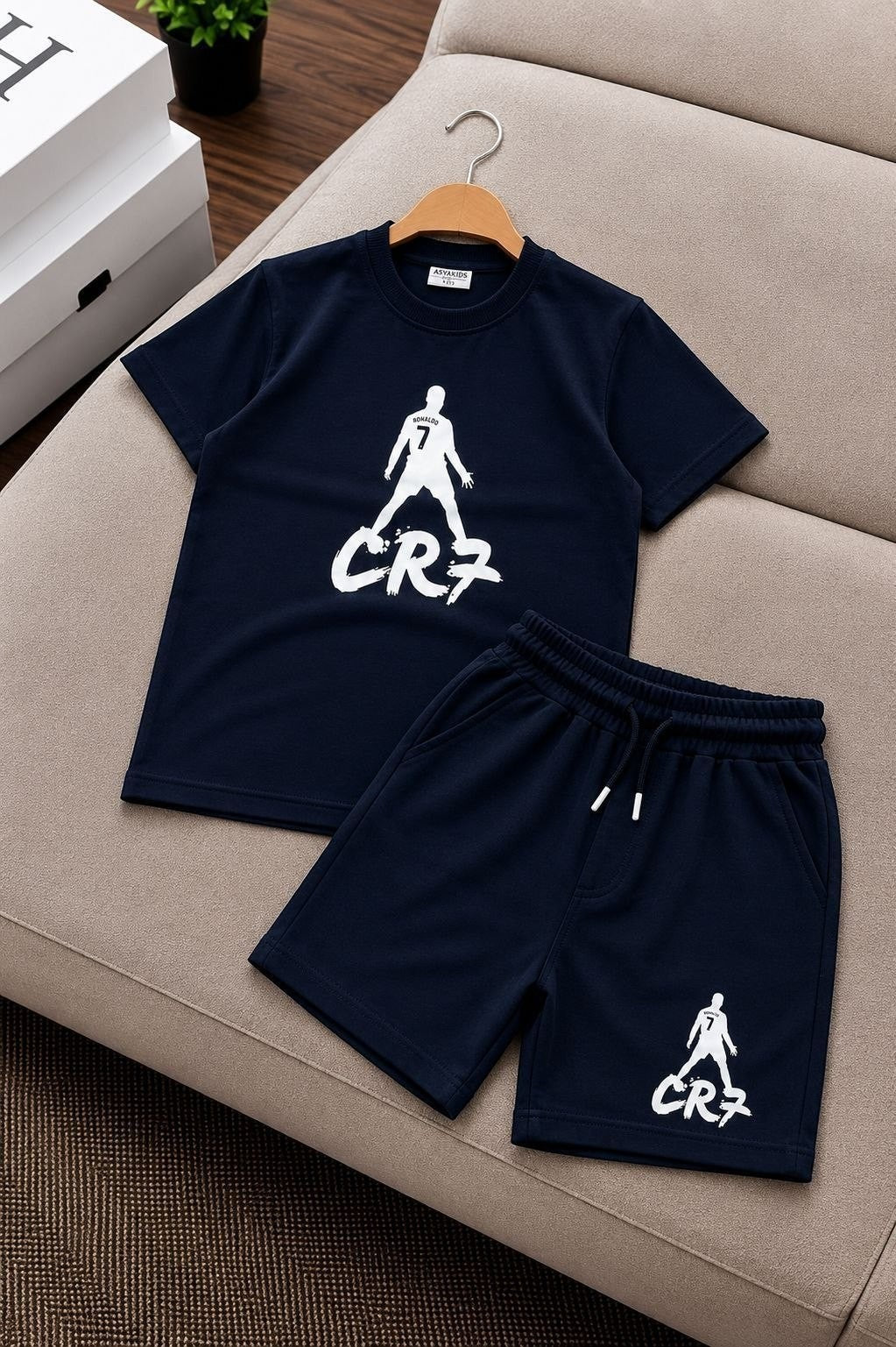 The Nile Luxuries navy blue CR7 graphic t-shirt and matching shorts set with elastic drawstring waist for active kids.