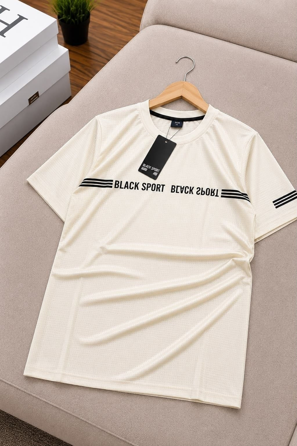The Nile Luxuries cream performance crew neck t-shirt with black chest stripes and micro-mesh breathable fabric.