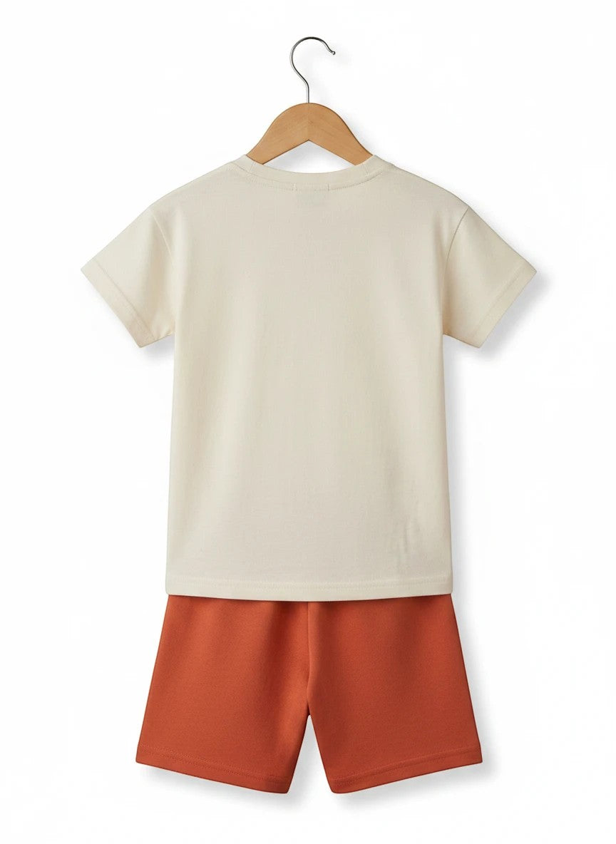 The Nile Luxuries children's casual set featuring a cream t-shirt and terracotta shorts on a wooden hanger