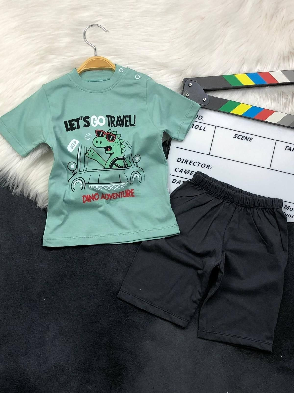 The Nile Luxuries toddler boys set with a green dinosaur graphic t-shirt and black shorts for summer play.