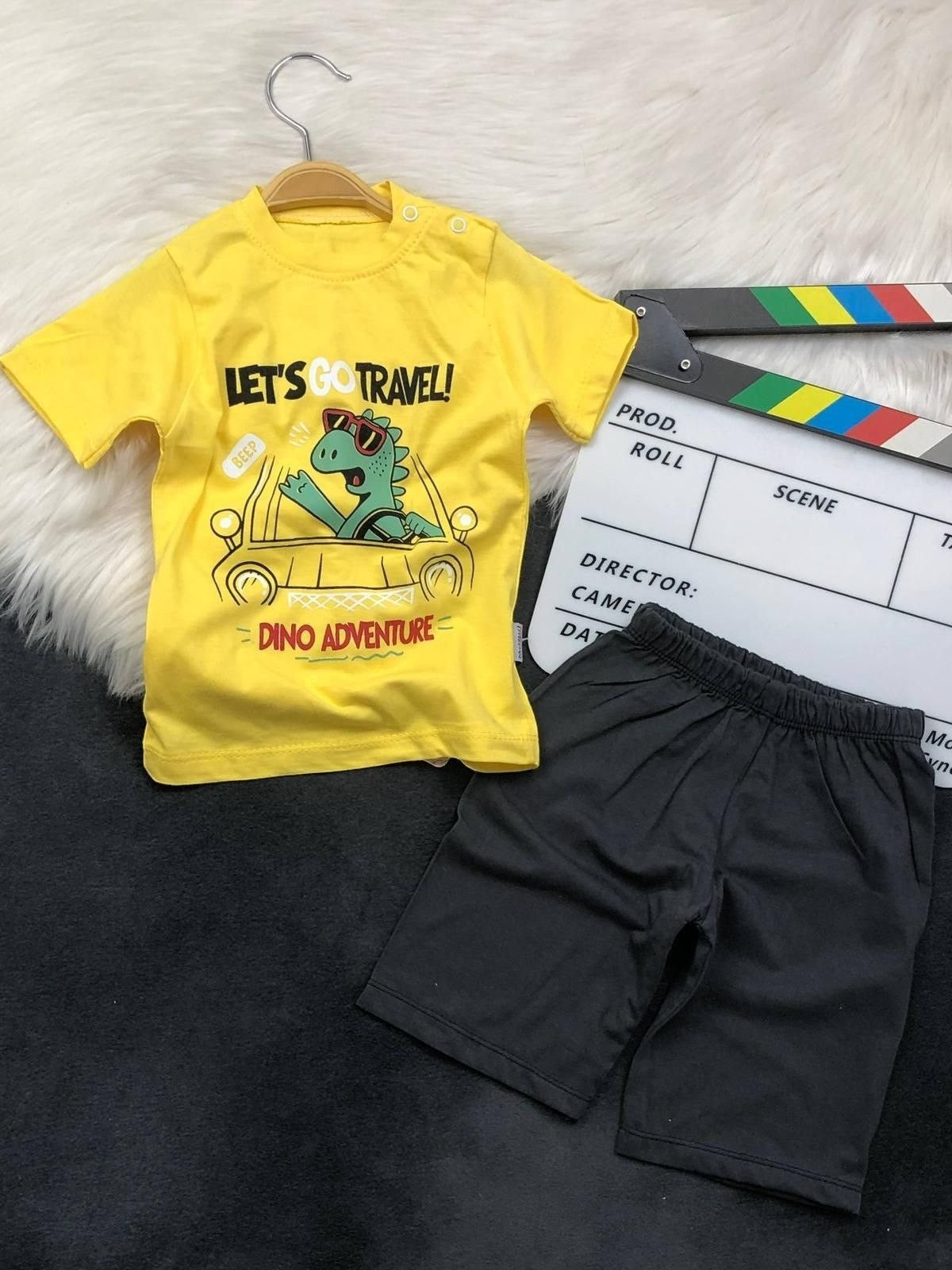 The Nile Luxuries toddler boys yellow dinosaur graphic t-shirt and black shorts set with shoulder snap buttons.