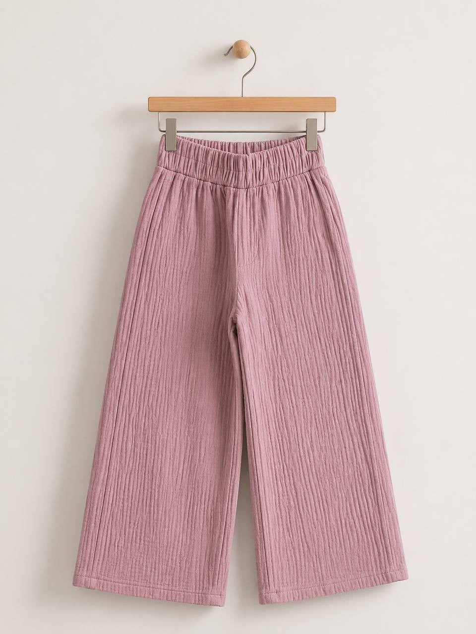 The Nile Luxuries dusty rose wide-leg trousers in crinkled cotton muslin with an elasticated high-rise waistband.