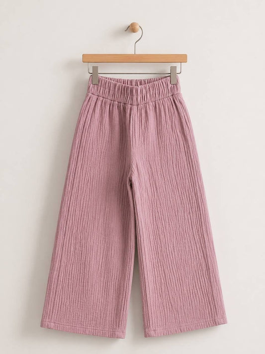 The Nile Luxuries dusty rose wide-leg trousers in crinkled cotton muslin with an elasticated high-rise waistband.