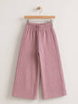 The Nile Luxuries dusty rose wide-leg trousers in crinkled cotton muslin with an elasticated high-rise waistband.