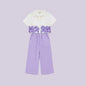 The Nile Luxuries white cropped shirt with purple floral embroidery and lavender wide-leg pants set.