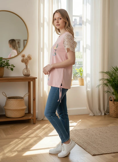 The Nile Luxuries pink cotton t-shirt with flamingo graphic and lace sleeves, featuring side ties.