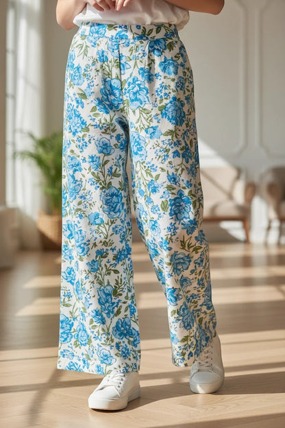 The Nile Luxuries girls lounge set featuring a white t-shirt and blue floral wide-leg trousers with white sneakers.