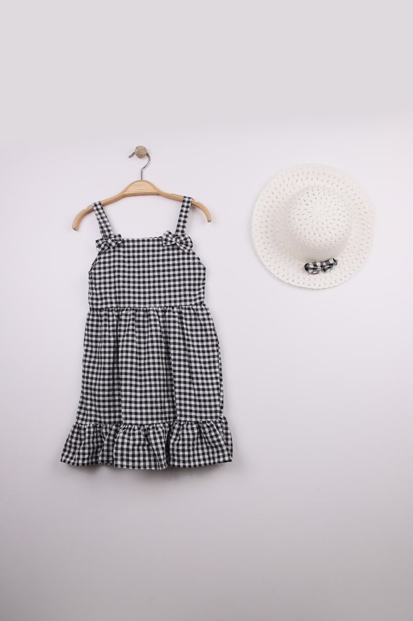 The Nile Luxuries black and white gingham ruffle dress with bow straps and matching hat. Lightweight fabric, perfect for summer.