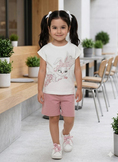 The Nile Luxuries girls summer outfit with a white bunny graphic t-shirt and pink shorts on a young girl