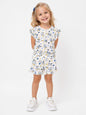 A young girl wearing The Nile Luxuries white ruffle lounge set with a cute bunny print, flutter sleeves, and shorts.