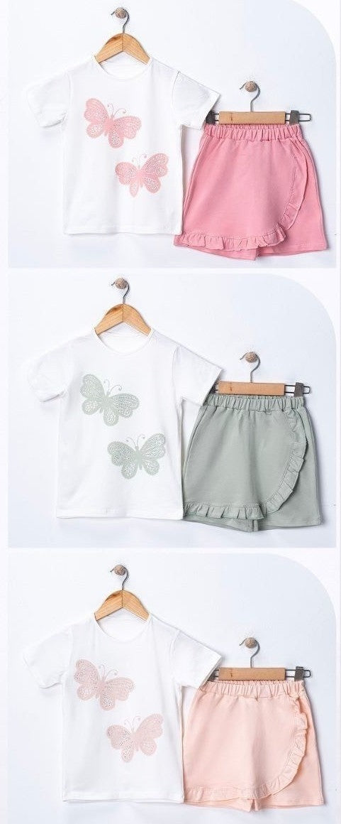 The Nile Luxuries girls' white cotton t-shirt with two pink butterfly appliques and a ruffled pink skirt.
