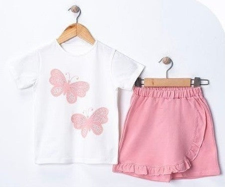 The Nile Luxuries white cotton t-shirt with pink glitter butterflies and pink ruffled skirt with elastic waist.