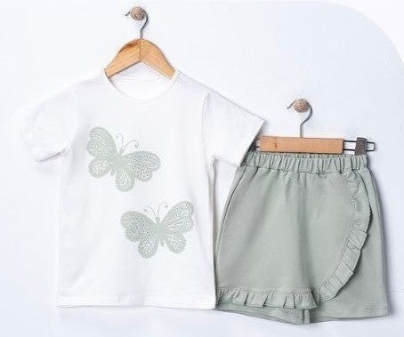 The Nile Luxuries girls' white cotton t-shirt with two sage green butterfly appliques and matching sage green ruffled skirt.