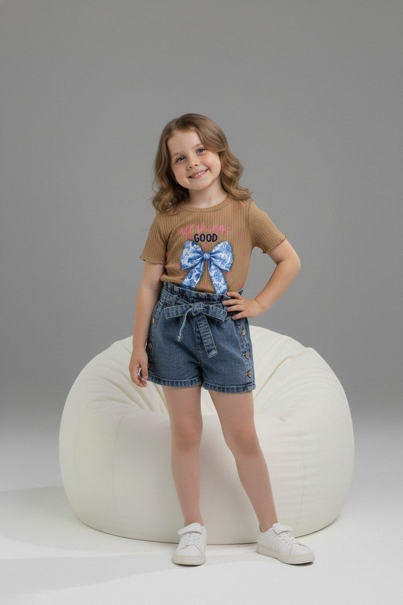 Girl wearing The Nile Luxuries ribbed brown graphic top with blue bow and denim paper-bag waist shorts with tie belt.