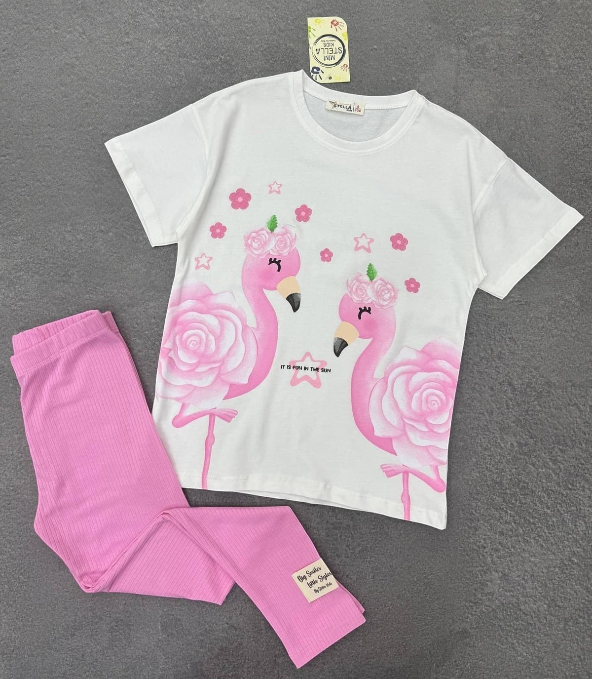 The Nile Luxuries girls two-piece set with white flamingo graphic t-shirt and pink ribbed leggings.