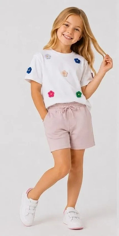 The Nile Luxuries girls' white cotton t-shirt with colorful floral appliques and lavender jersey shorts with drawstring.