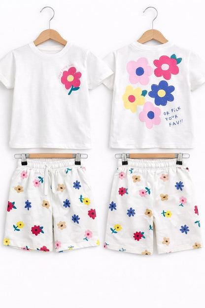 The Nile Luxuries girls white cotton-blend lounge set with vibrant floral graphics on the t-shirt and matching shorts.