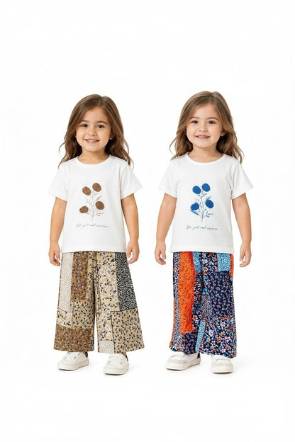 The Nile Luxuries girls' two-piece set with white graphic tees and colorful patchwork wide-leg floral trousers.