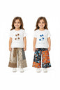 The Nile Luxuries girls' two-piece set with white graphic tees and floral patchwork wide-leg pants on a young model.