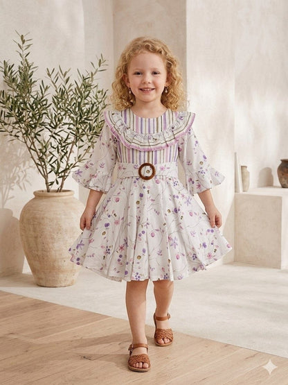 The Nile Luxuries Girls floral print dress with ruffle collar, bell sleeves, and wooden buckle belt. White with purple floral print.