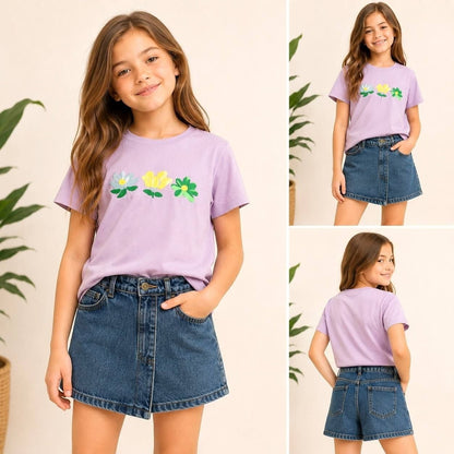 Girl wearing The Nile Luxuries lavender floral embroidered t-shirt and blue denim skort set for casual play.
