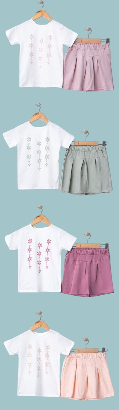 The Nile Luxuries girls' white t-shirt with floral print and pink pleated skirt set. Soft, breathable fabric.