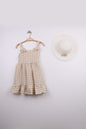 The Nile Luxuries girls' beige gingham dress with bow straps and ruffle hem, paired with a matching hat.