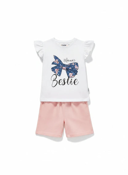 The Nile Luxuries white cotton t-shirt with floral bow graphic and "Mama's Bestie" slogan, paired with pink shorts.