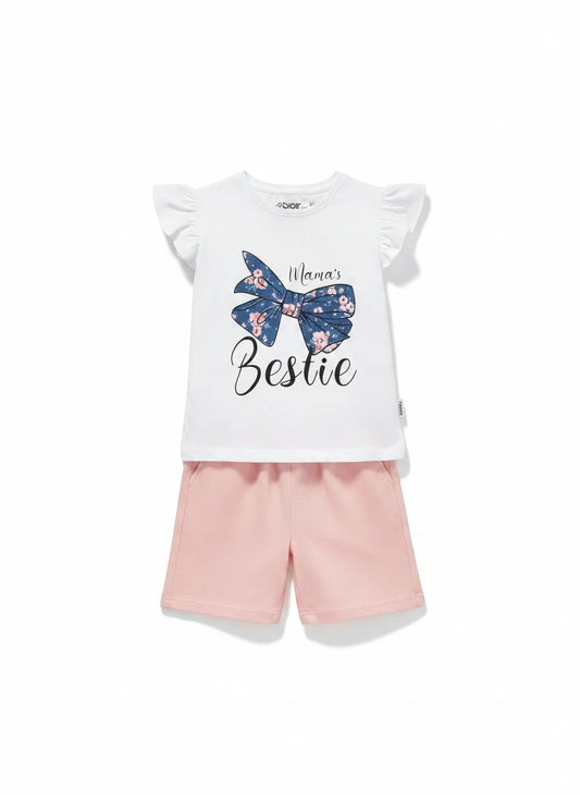 The Nile Luxuries white cotton t-shirt with floral bow graphic and "Mama's Bestie" slogan, paired with pink shorts.