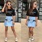 The Nile Luxuries girls black Beautiful graphic t-shirt and light blue pleated skirt set with bow accents.