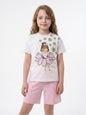 Girl wearing The Nile Luxuries white graphic t-shirt with daisy print and pink shorts with front seam detail.