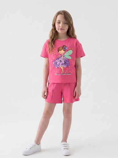 Girl wearing a pink The Nile Luxuries graphic t-shirt and matching shorts with a fairy print and front seam detail.