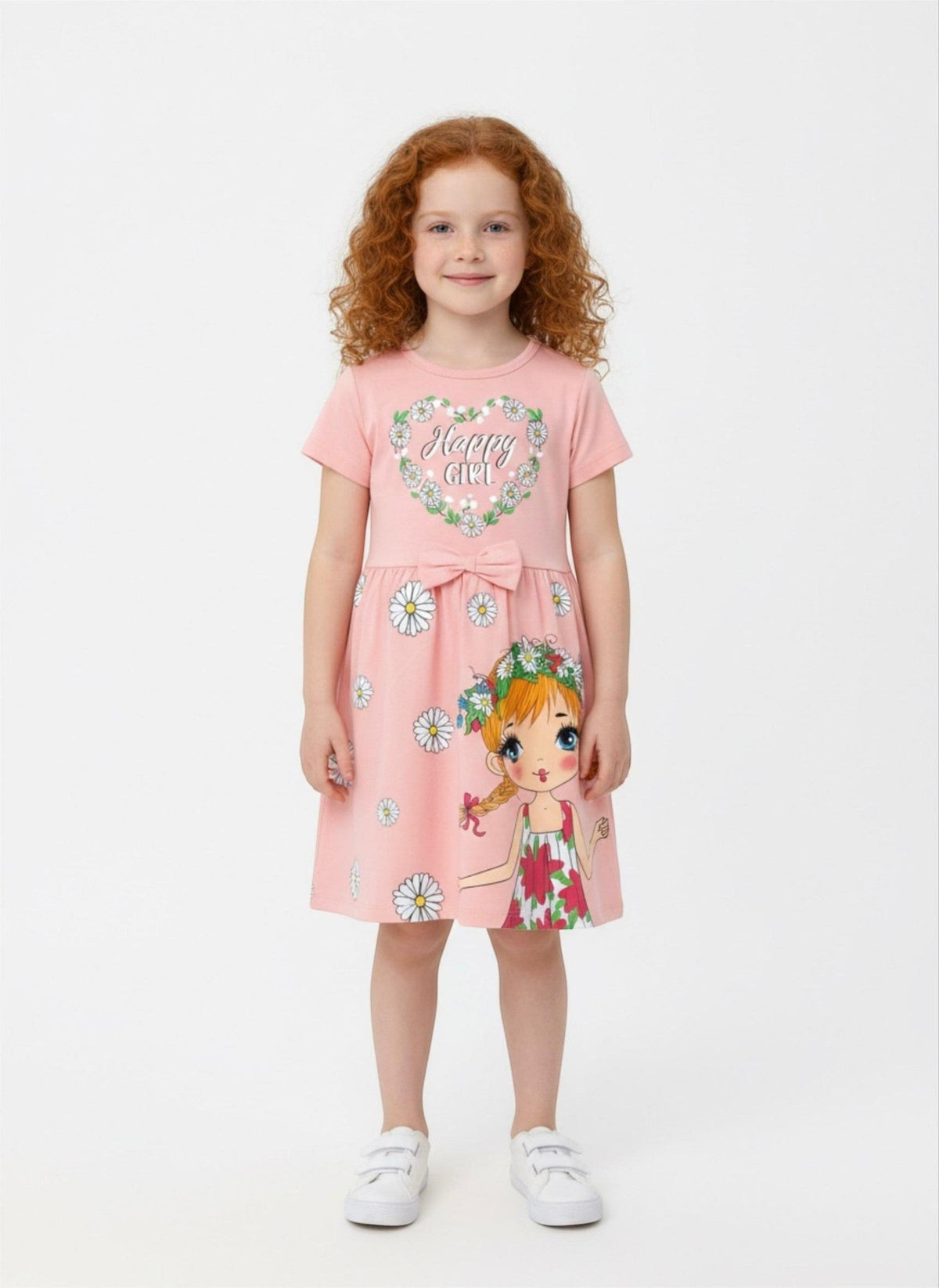 The Nile Luxuries pink short-sleeve dress with daisy print, Happy Girl graphic, and waist bow on a young girl.