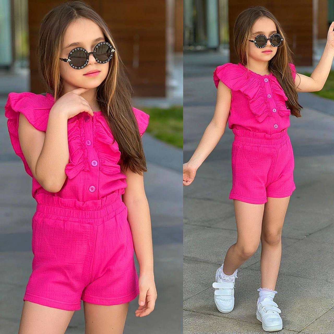 A young girl wearing a bright pink The Nile Luxuries ruffle top and shorts set with white sneakers and sunglasses.