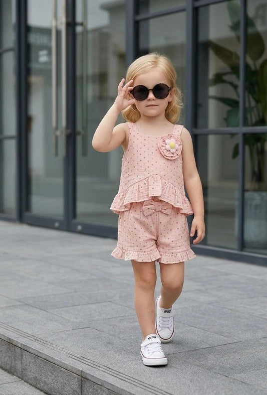 The Nile Luxuries blush pink polka dot cotton blend shorts set with ruffles and floral applique. Sleeveless top and elastic waist shorts.