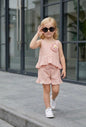 The Nile Luxuries blush pink polka dot cotton blend shorts set with ruffles and floral applique. Sleeveless top and elastic waist shorts.