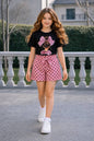 The Nile Luxuries girls pink polka dot shorts set with black graphic tee featuring a bow detail.
