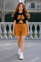 The Nile Luxuries girls' black t-shirt with graphic and yellow polka dot shorts set. Features tie-waist shorts.