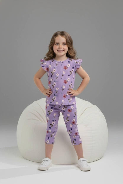 Girl wearing The Nile Luxuries purple ribbed floral lounge set with flutter sleeves and cropped leggings on beanbag