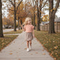 The Nile Luxuries peach cotton t-shirt with ruffled sleeves and a taupe wrap skirt with ruffled trim.