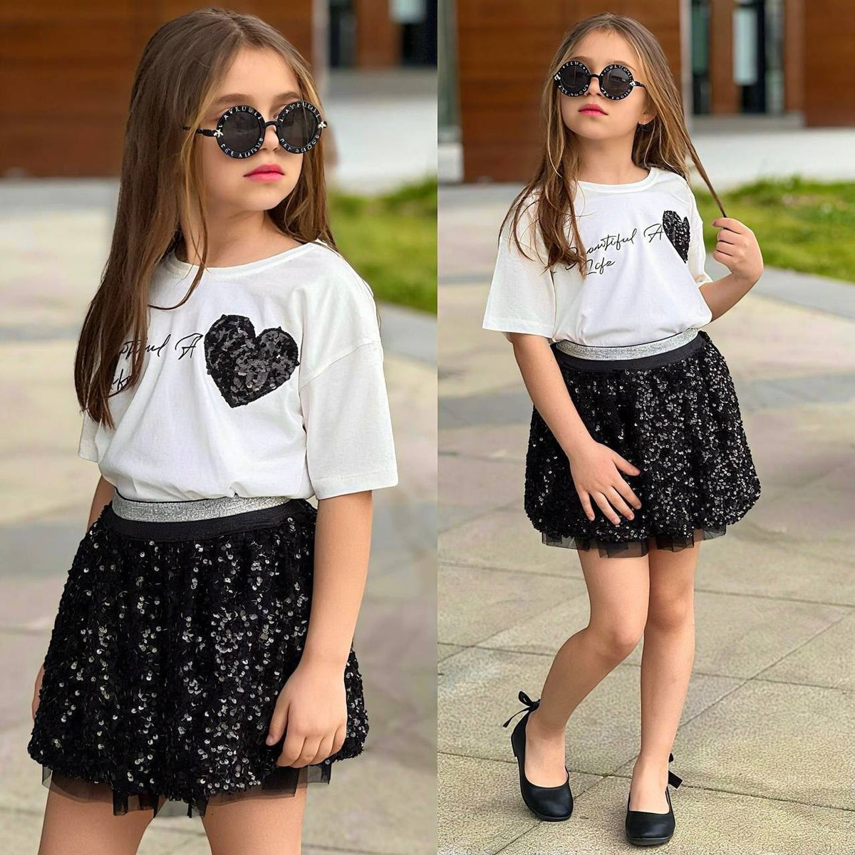 The Nile Luxuries girls outfit set with a white graphic t-shirt and a black sequin tulle skirt worn by a young girl.